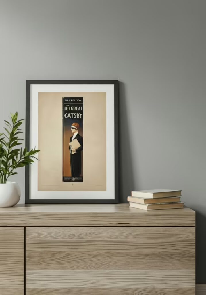 25 Best Gifts for Book Lovers (Unique Ideas Every Reader Will Love) 6 A framed art print of the first edition cover of 'The Great Gatsby' on a wall.