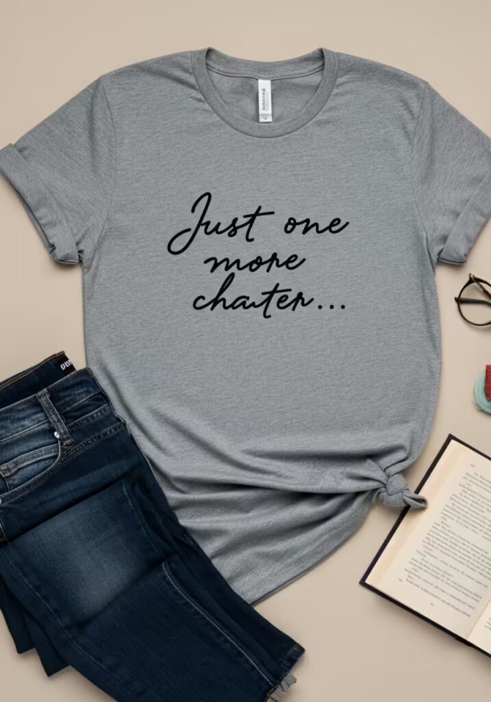 25 Best Gifts for Book Lovers (Unique Ideas Every Reader Will Love) 3 A flat lay of a minimalist t-shirt with a book-related quote, paired with jeans and glasses