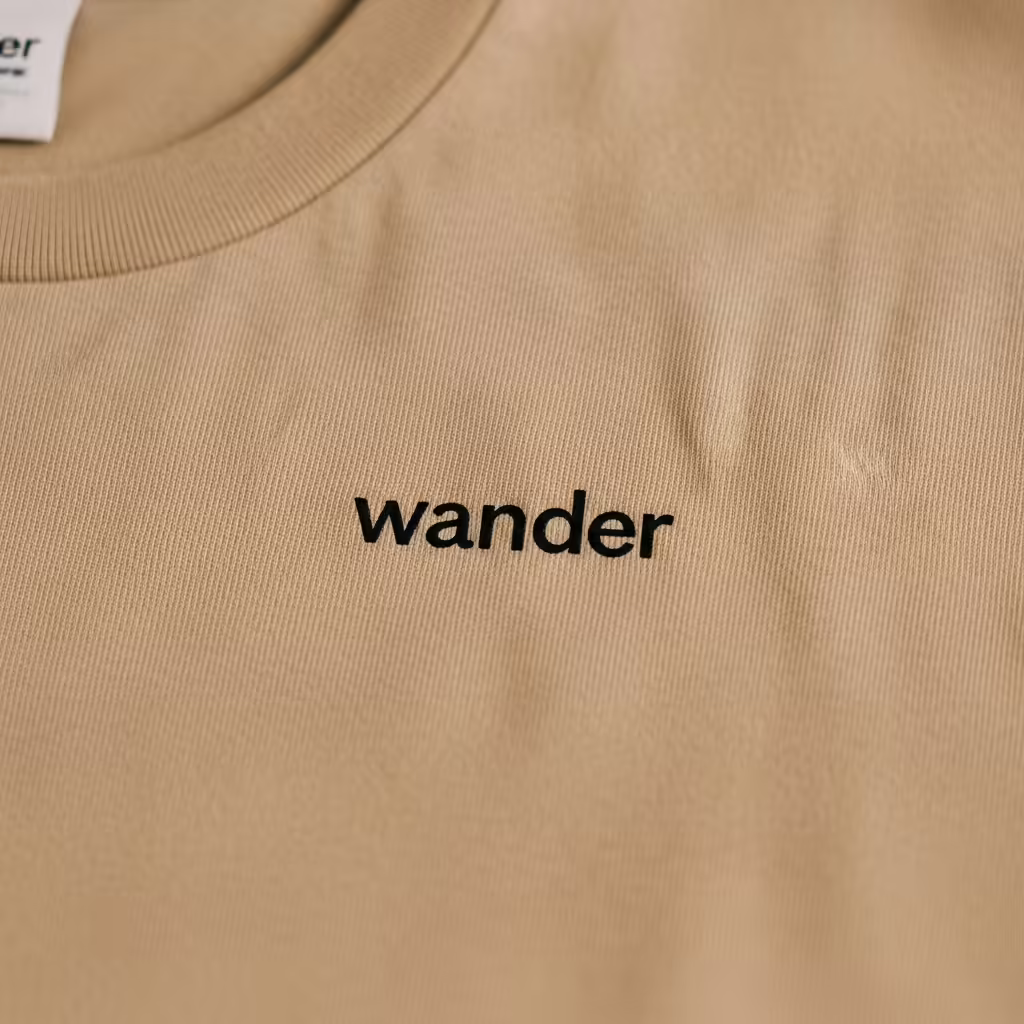 Minimalist T-Shirt Design Ideas: The Art of 'Less is More' Trends 3 A minimalist t-shirt featuring a single word 'wander' in a clean sans-serif font.